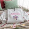 Snowy Angel Skating Embroidered Sweatshirt, Pink Angel Christmas Lights Hoodie, Custom Holiday Experiment 624 Crewneck, Gift for Him Her