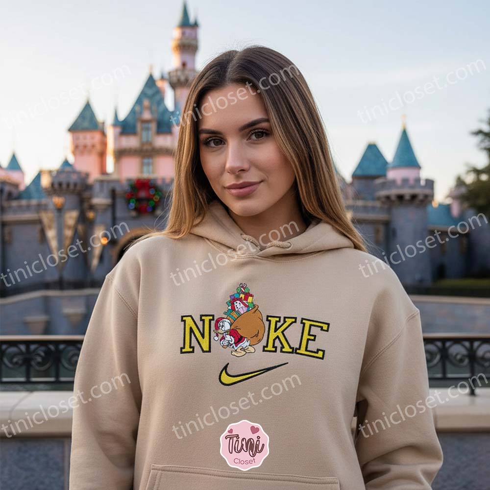 Embroidered Donald Duck Christmas Sweatshirt, Retro Holiday Cartoon Crewneck, Funny Santa Sack Graphic, Boyfriend Hoodie Gift Embroidered Donald Duck Christmas Sweatshirt, Retro Holiday Cartoon Crewneck, Funny Santa Sack Graphic, Boyfriend Hoodie Gift