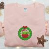 Baby Yoda With Christmas Wreath Embroidered Shirt, Christmas Embroidered Hoodie, Best Gifts For Family