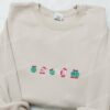 Kirby Eating Christmas Ornament Embroidered Shirt, Game Character Embroidered Hoodie, Christmas Embroidered Sweatshirt